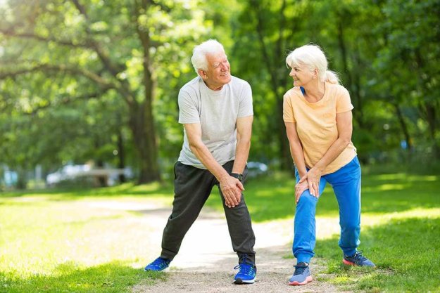 Senior Couple Exercising In Park Senior Couple Exercising In Park