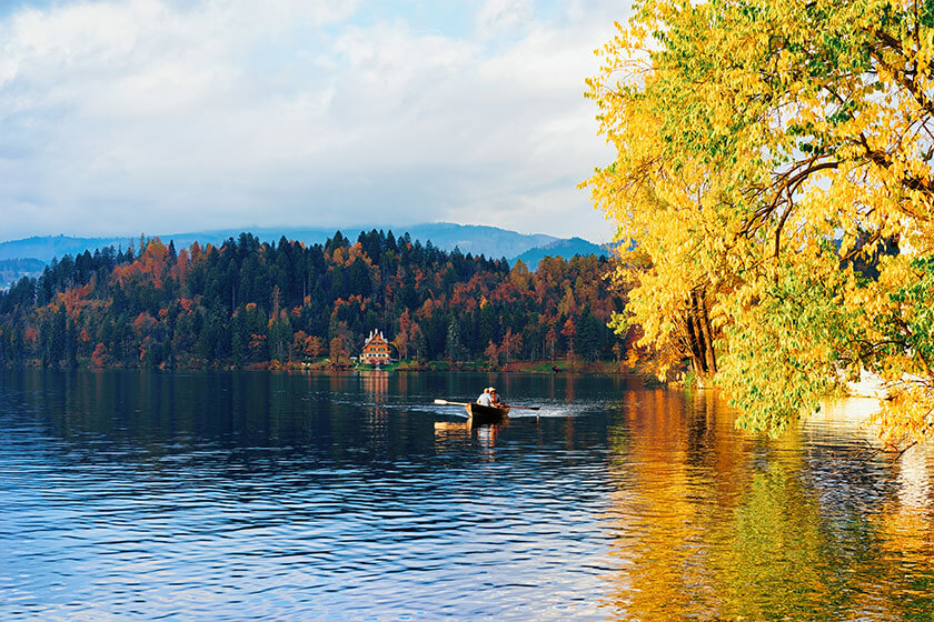 Beautiful landscape of Bled Lake and senior people in boat