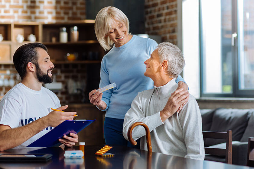 Cheerful smiling loving wife smiling while coming to her senior husband