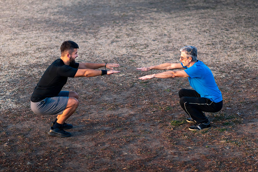 Men stretching before workout outdoors Men stretching before workout outdoors