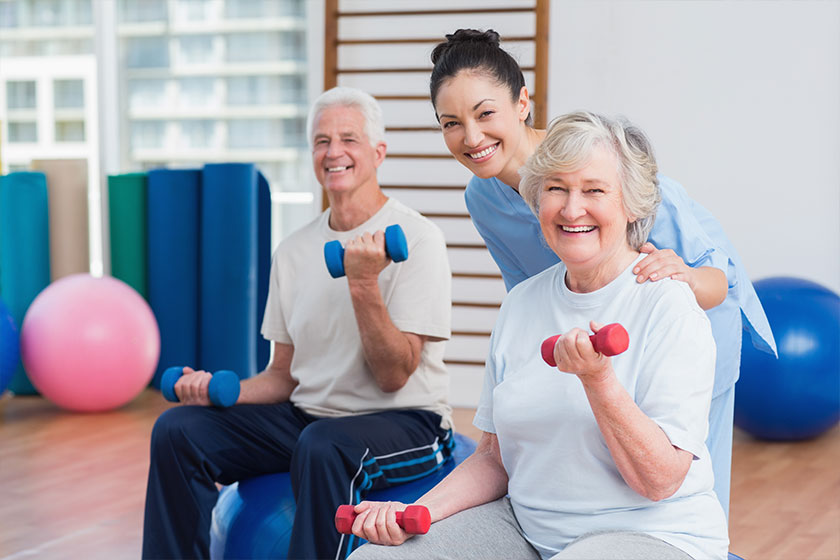 Portrait of happy instructor with senior couple