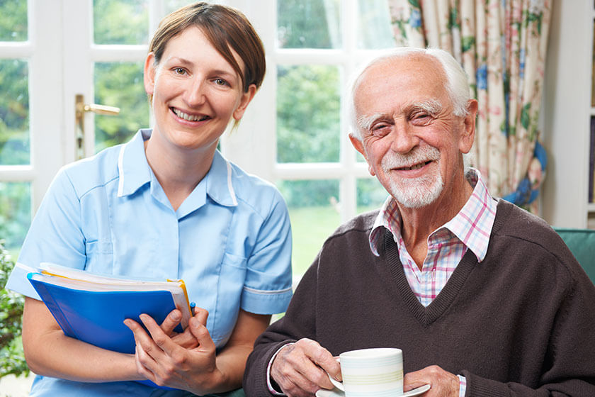Senior Man With Carer At Home