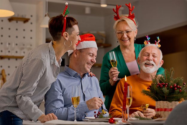 Different generation caucasian family toasting with sparkling wine celebrating Christmas Different generation caucasian family toasting with sparkling wine celebrating Christmas