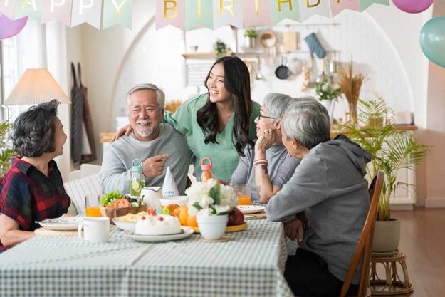 Group of Asian senior people having birthday party at home Group of Asian senior people having birthday party at home