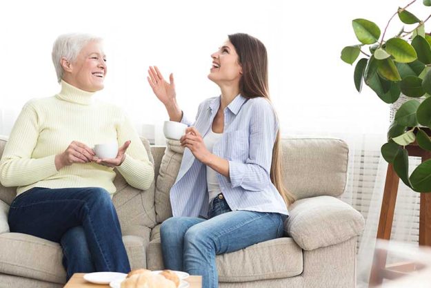 Mother and daughter drinking coffee and talking