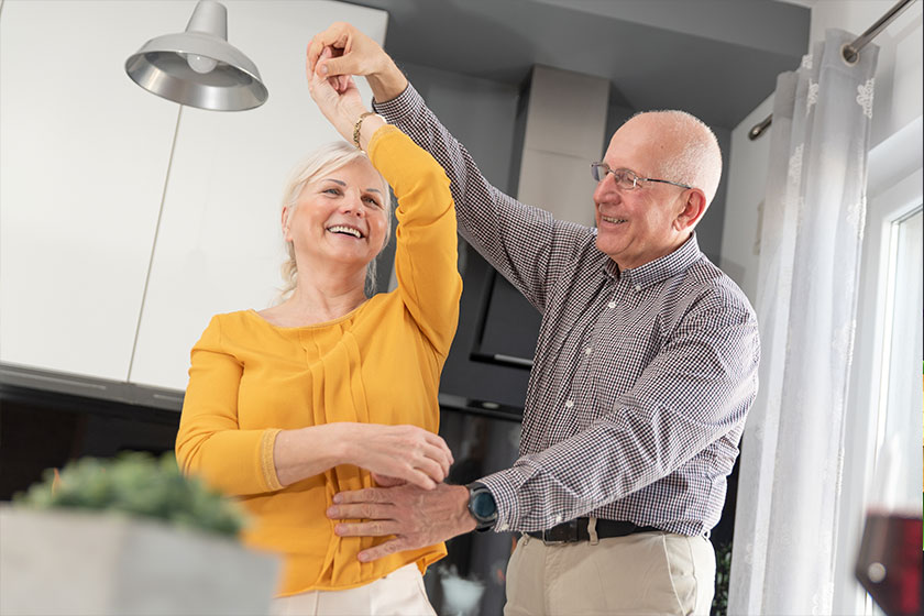 Senior couple dancing and smiling at home Senior couple dancing and smiling at home