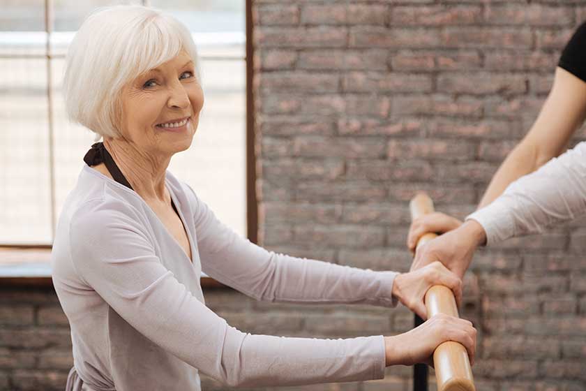 Happy charming pensioner dancing in the dance studio