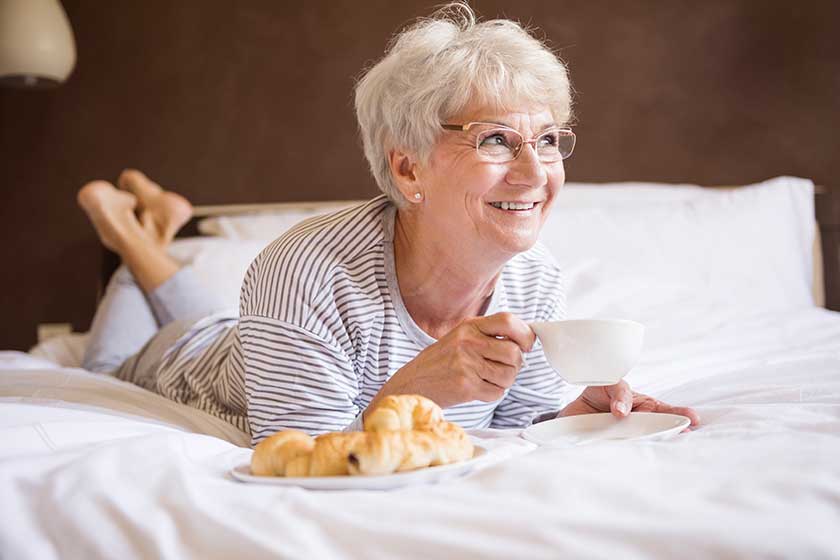 Mature woman eating breakfast Mature woman eating breakfast