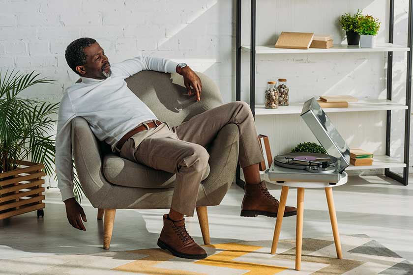Senior African American Man Stylish Clothes Sitting Armchair Listening Music