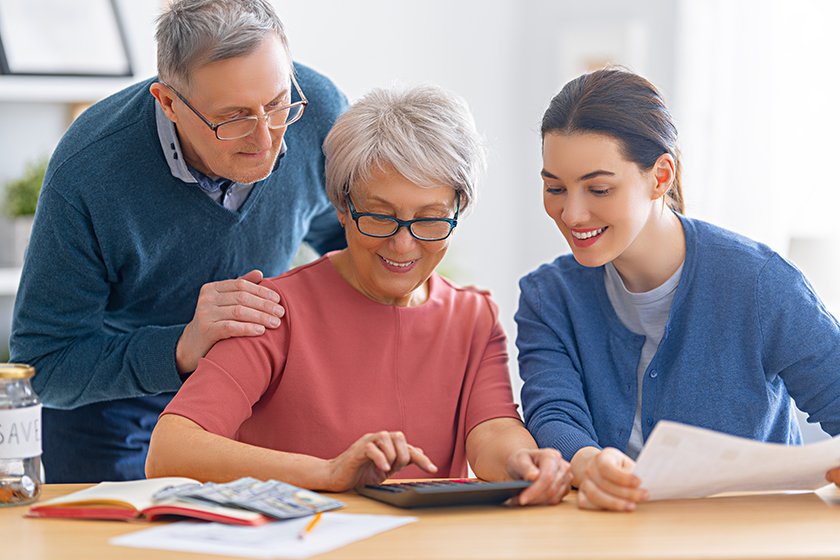 Family sitting at the desk with a paper receipt Family sitting at the desk with a paper receipt