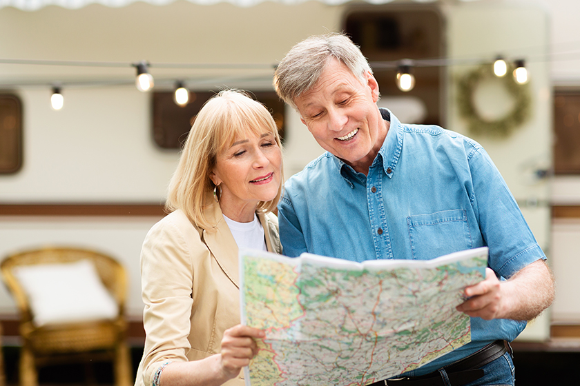 Happy senior man and his wife reading map Happy senior man and his wife reading map