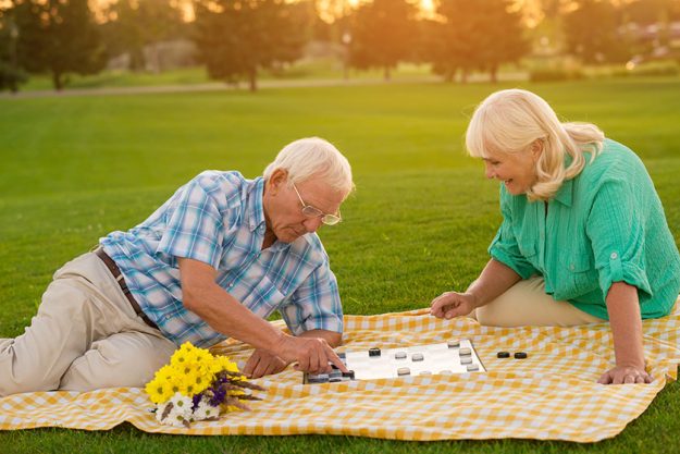 Senior couple plays checkers. Senior couple plays checkers.
