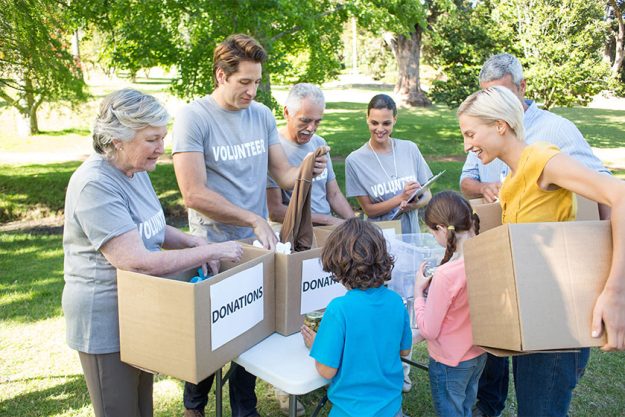 Volunteer family separating donations stuffs