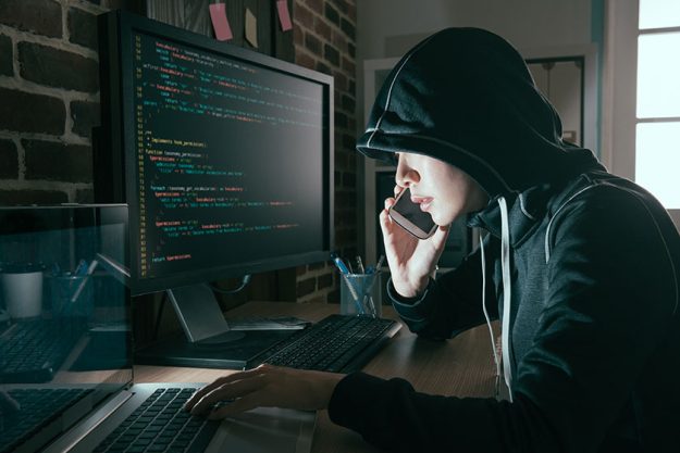 Hacker woman hidden face using mobile cell phone