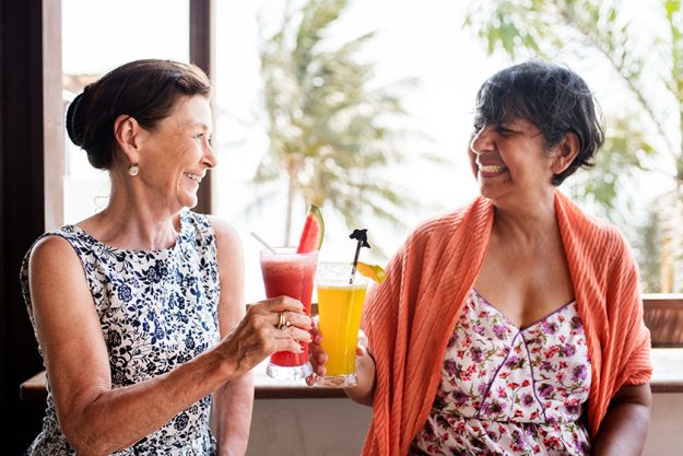 Senior women enjoying drinks in the summertime Senior women enjoying drinks in the summertime