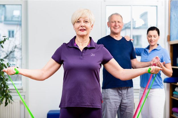 Physio showing how to use rubber band Physio showing how to use rubber band