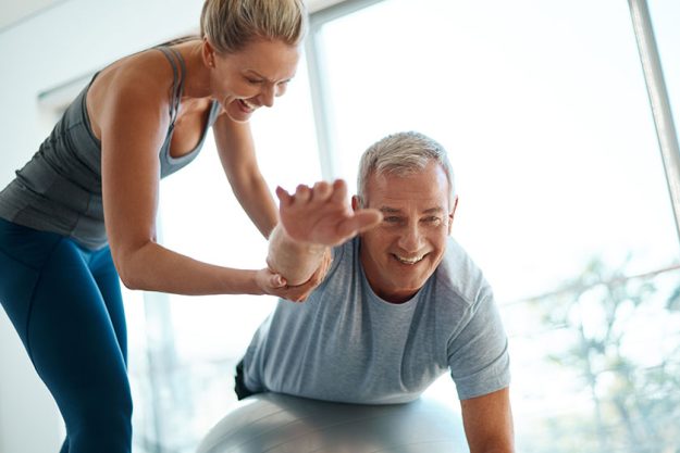 Your goals are within reach. Cropped shot of an attractive mature woman helping her husband with his workout at home. Your goals are within reach. Cropped shot of an attractive mature woman helping her husband with his workout at home.