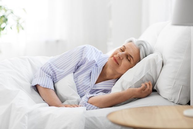 Senior woman sleeping in bed at home bedroom Senior woman sleeping in bed at home bedroom