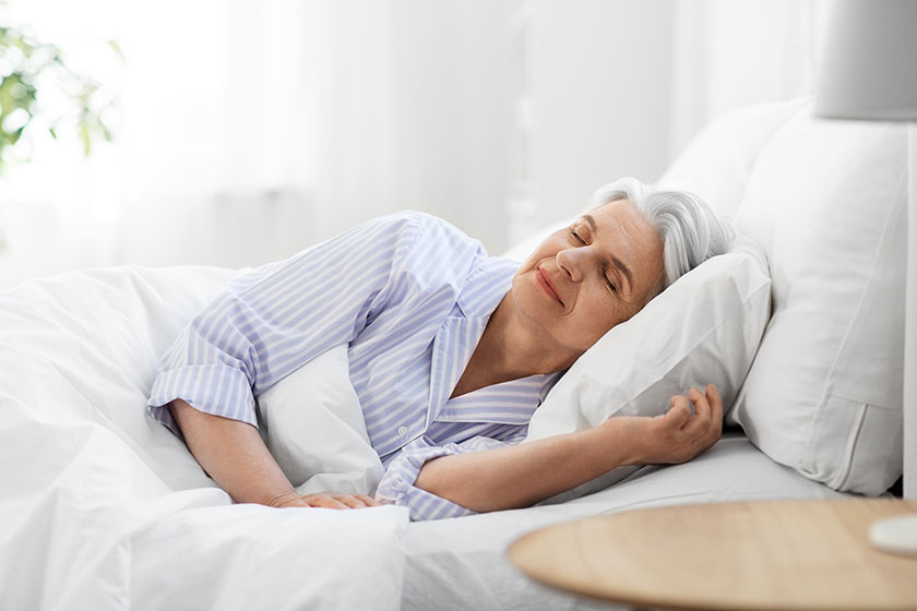 Senior woman sleeping in bed at home bedroom Senior woman sleeping in bed at home bedroom