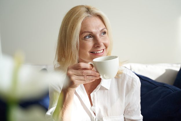 Smiling-pretty-lady-is enjoying-hot-drink Smiling-pretty-lady-is enjoying-hot-drink