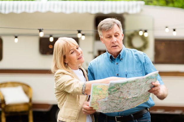 Mature couple looking at map and trying to find direction
