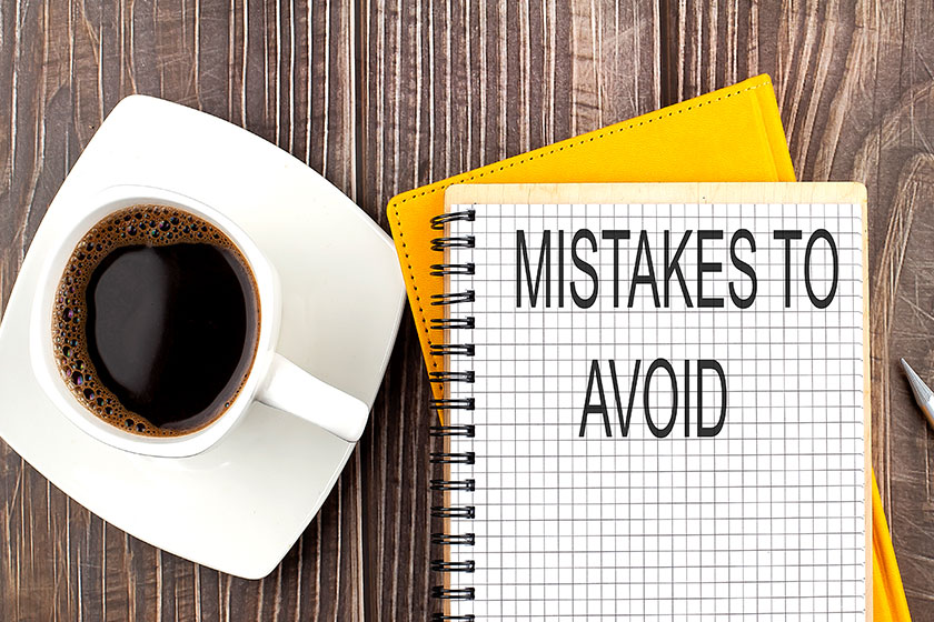 MISTAKES TO AVOID text on the notebook MISTAKES TO AVOID text on the notebook