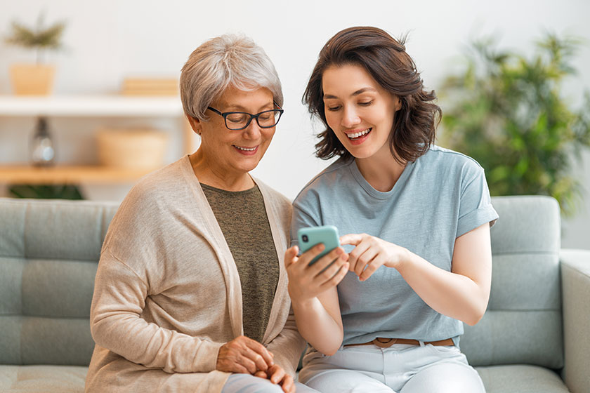 Young and senior women are using smartphone