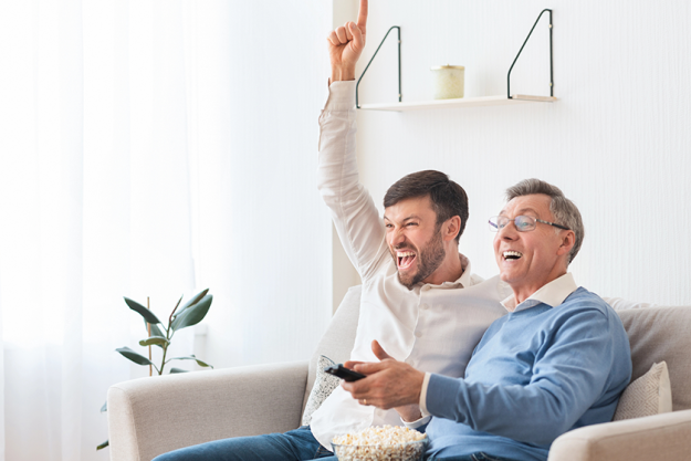 adult-son-and-senior-father-watching-sports