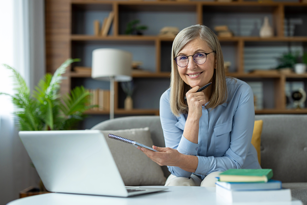 smiling-senior-woman-working-home-using-laptop smiling-senior-woman-working-home-using-laptop