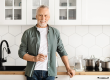Cheerful mature man holding glass of water