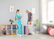 Female doctor physiotherapist or nurse weighing a senior patient