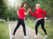 Two beautiful adult women doing sports with dumbbells