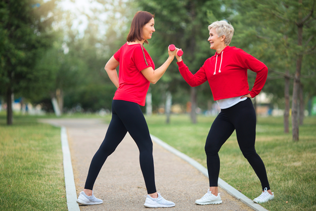 two-beautiful-adult-women-doing-sports-dumbbells Two beautiful adult women doing sports with dumbbells
