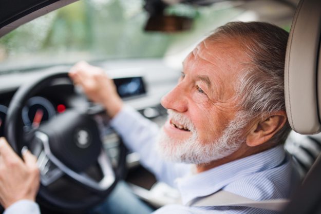 Close-up,Of,Happy,Senior,Man,Sitting,In,Car,In,Driver